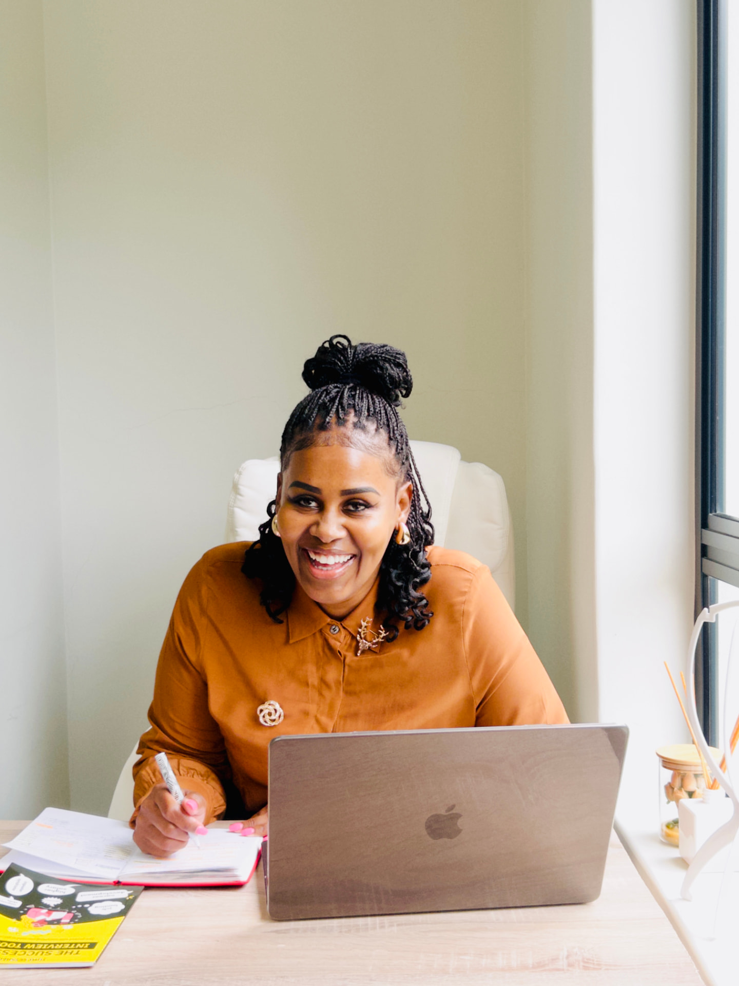 Tumi Setshedi smiling at her desk